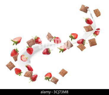 Splashing milk with sweet corn pads and fresh strawberries in air against white background. Healthy breakfast Stock Photo