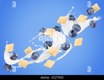 Splashing milk with sweet corn pads and fresh blueberries in air against blue background. Healthy breakfast Stock Photo