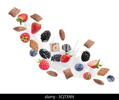 Splashing milk with sweet corn pads and fresh berries in air against white background. Healthy breakfast Stock Photo