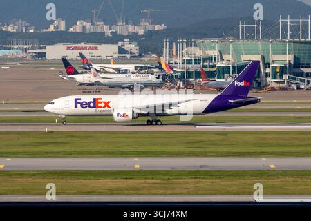 FedEx Express Boeing 777-FS2 cargo plane is unloaded, air freight
