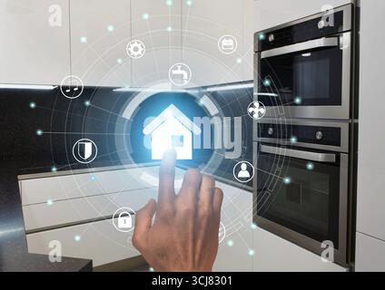Smart technologies. Millennial guy using modern home control system in kitchen, collage with icons on virtual screen Stock Photo