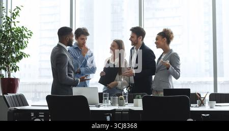Diverse management team talking in conference room Stock Photo