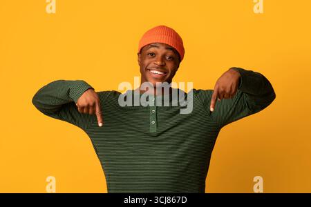 Look At This. Excited Black Guy Pointing Down With Two Hands Stock Photo