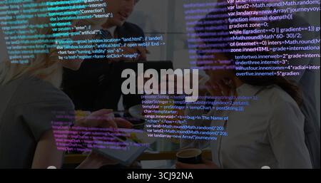 Reviewing tech team wearing business attire discussing code at table in office, with code overlay Stock Photo