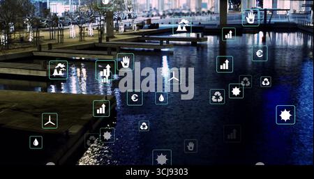 Floating digital icons hovering above waterfront at night, with wooden docks, benches and lamps Stock Photo
