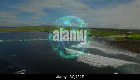 Displaying globe hologram at coastal shoreline, with numeric overlays and triangular particles Stock Photo
