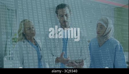 Discussing data medical team collaborating in hospital corridor, with stethoscopes, digital overlay Stock Photo