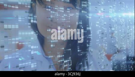 Female scientist studying translucent digital data overlay in research lab, wearing lab coat Stock Photo