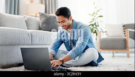 Man, remote work and typing on laptop at house for research, review article and editing draft. Journalist, freelancer and pc for proofreading, story Stock Photo