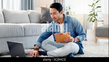 Man, relax and typing on laptop at house for research, review article and editing draft. Journalist, freelancer and tablet with pc for proofreading Stock Photo