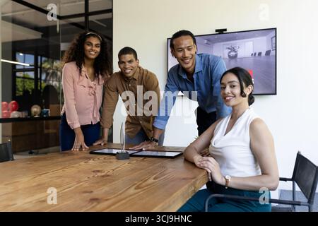 Diverse business team collaborating around conference table in modern office Stock Photo