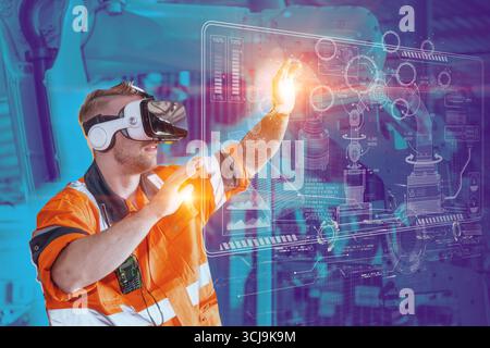 Engineer male using VR virtual reality goggle headset device to control operate robot arm in modern technology industry Stock Photo