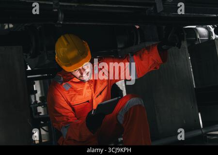 Professional engineer hispanic latin male service leakage check maintenance underground valve pipeline using tablet digital device technology Stock Photo