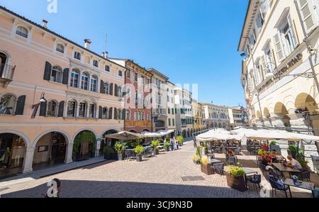 Picturesque view of light colored buildings and terraces in the center of the historic city of Udine, northeastern Italy. Stock Photo