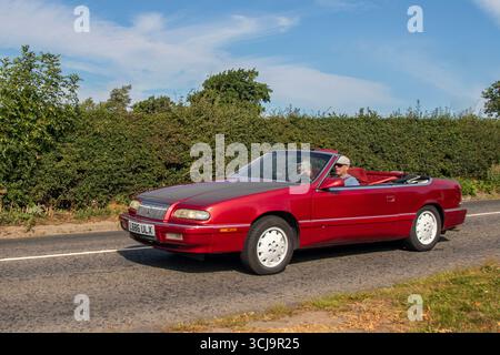 1994 90s nineties Red Chrysler LeBaron Cabriolet, 3.0L V6 front-wheel drive, automatic,  convertible Petrol 3000 cc car; travelling to Congleton, Cheshire Classic Car Show, UK Stock Photo