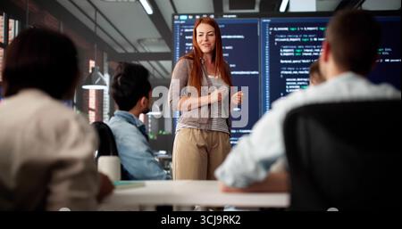 Coders In Diverse Group Attend Professional Development Meeting At Office Stock Photo