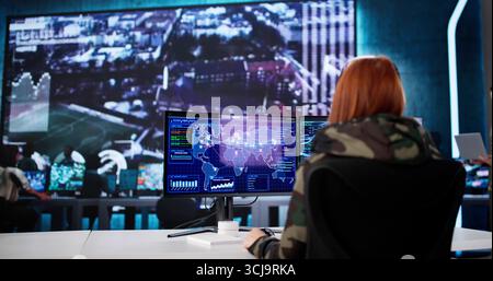 Innovative Military Agent Coordinates Operations In High-Tech Command Center Stock Photo