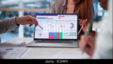 Multicultural Team Analyzing Demographic Data In Collaborative Business Meeting Stock Photo