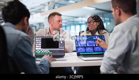 Skilled Video Editor Creates Montage Using Web Software On Computer. Stock Photo