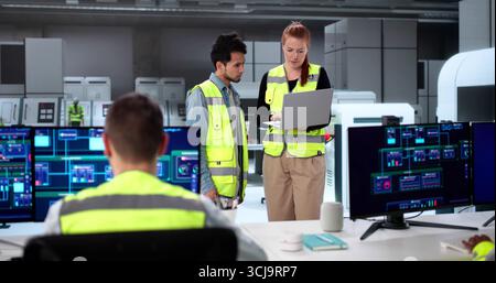 Modern SCADA Software In Industrial Plant Control - Diverse Team Learning Stock Photo
