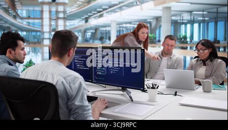 Multiracial Coding Team Developing Software In Modern Business Office Setting Stock Photo