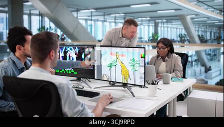 Multiracial Team Of Graphic Designers Editing Print Designs On Computers Stock Photo