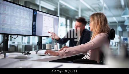 Professional Billing Specialists Working In Office Using Desktop Computer Screen Stock Photo