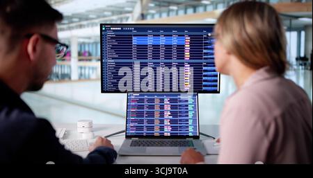 Professional Couple Analyzing Financial Data For Business Audit Using Computer. Stock Photo