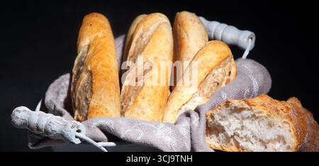 Fresh bread on black background. Traditional bakery concept. Stock Photo