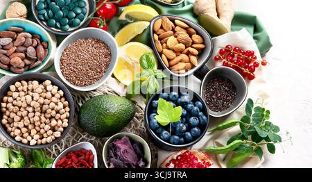 Healthy food on white background . Fresh fruits , superfoods an vegatables . High in antioxidants, vitamins, minerals, fiber. Top view with copy space Stock Photo