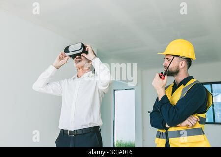 Construction project manager using VR visual modern technology device for check inspecting house building project Stock Photo