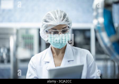 Industry inspector team working, QC staff work checking machine operation for safety and hygiene Stock Photo