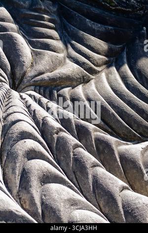Unique textures and patterns formed on a stone surface show the effects of natural erosion over time. Stock Photo