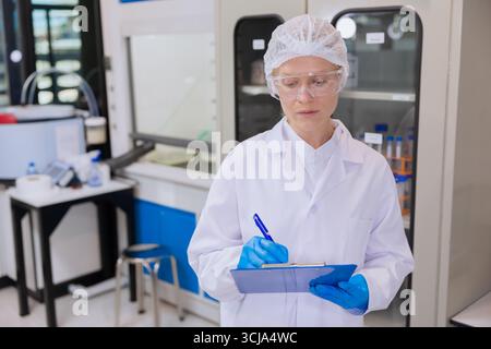 science people, lab technician, medical lab people hand holding chart sheet check board for medical research information Stock Photo