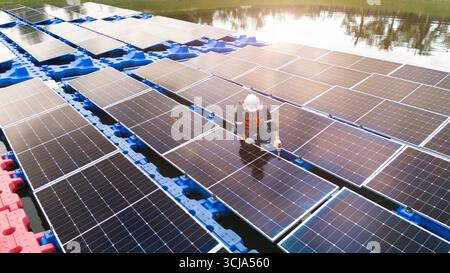 Professional engineer installation, cleaning, service maintenance floating solar panels photovoltaic clean energy system Stock Photo