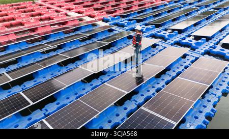Professional engineer installation, cleaning, service maintenance floating solar panels photovoltaic clean energy system Stock Photo