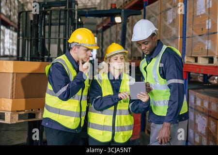 staff team warehouse workers. professional factory cargo storage working discussion. stock inventory people talking about products logistic plan in ta Stock Photo