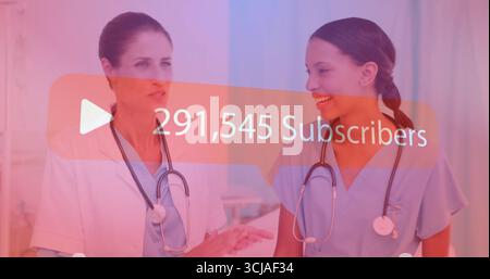 Medical team posing in hospital corridor, with scrubs, lab coat, stethoscopes  and  subscriber icon Stock Photo
