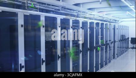 Displaying server cabinets with blue LEDs and cable trays in data center corridor, with black chair Stock Photo
