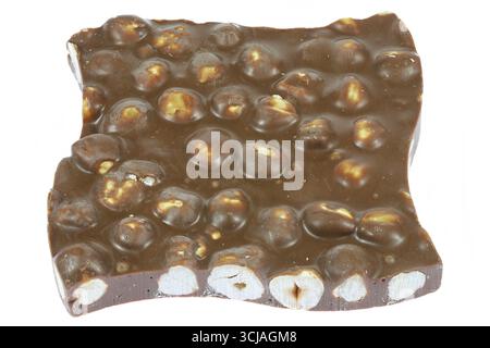 handmade broken chocolate with hazelnuts isolated on white background Stock Photo