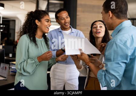 Diverse business team discussing project and sharing ideas in modern office Stock Photo