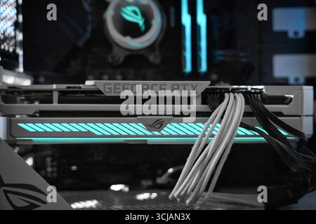 Advanced computer graphics card showcasing sleek design and vibrant lighting in a modern gaming setup Stock Photo