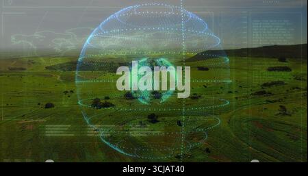 Rotating holographic Earth globe over rural farmland, with concentric rings and text overlays Stock Photo