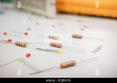 Assortment of resistors and LEDs on white surface Stock Photo