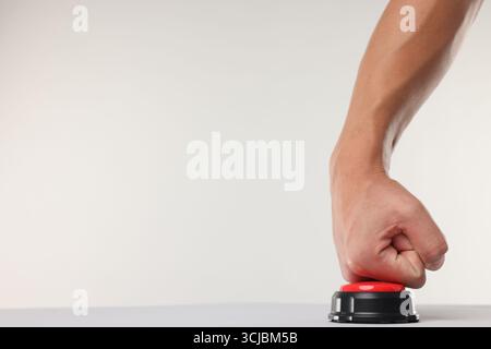 Man pressing red button on white background, closeup. Space for text Stock Photo