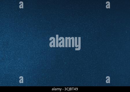 Abstract shiny, radiant texture background with different shades of dark blue color. Painted canvas, glitter concrete surface, studio backdrop, grainy Stock Photo