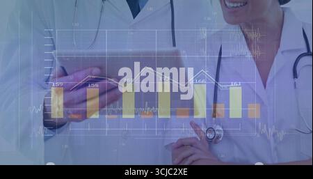 Two doctors in coats with stethoscopes using tablet at clinic, with bar and line chart overlay Stock Photo