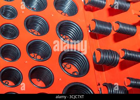 New rubber O-rings in different sizes stacked in an organizer box, close up Stock Photo