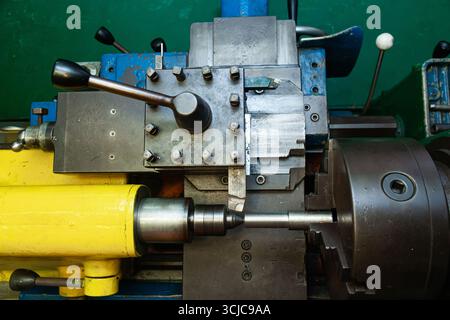Mechanical processing of metal on a lathe, close-up. The steel bar is clamped in the lathe and the cutter is brought in. Stock Photo