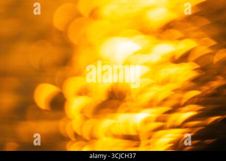 An abstract depiction of a vibrant sunset over the salt flats in donana, Cadiz. The golden hues and soft focus create a dreamlike ambiance, capturing Stock Photo